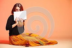 Autumn fashion girl with book orange eye-lashes
