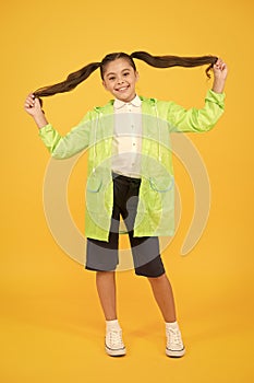 Autumn fashion for kids. dry and comfortable. Rain is not hindrance. small girl have fun in raincoat. active schoolgirl