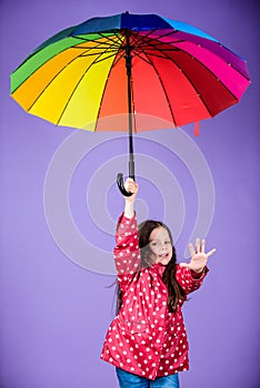 Autumn fashion. rain protection. Rainbow. cheerful hipster child in positive mood. happy little girl with colorful