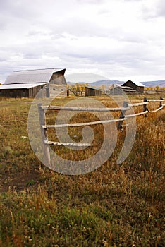 Autumn, fence and old western farm buildings