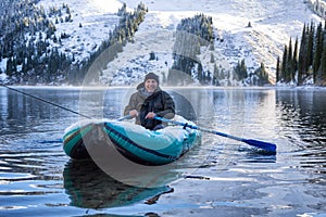 Autumn fishing under snowfall