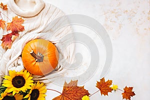 Autumn flat lay background with  pumpkin , sweater and golden sunflowers