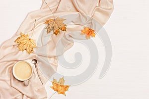 Autumn flat lay with cup coffee cappuccino and yellow autumnal leaves