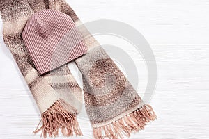 Autumn flat lay with warm woolen scarf and knitted cap. Fashion autumn clothes