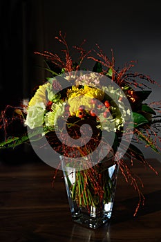 Autumn flower bouquet, light spots on colorful flowers with dark background