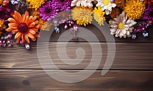 Autumn flowers frame on wooden background. Seasonal yellow and red flowers. Autumn background. Space for text