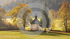 Autumn foggy country with a chapel