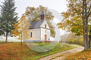Autumn foggy country with a chapel under the Podskalsky Rohac
