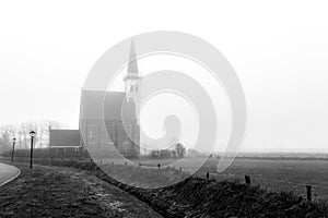 Autumn foggy morning, church of Den Hoorn on Texel island in the Netherlands