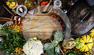 Autumn food background with organic farm vegetables: cauliflower, broccoli, root celery, pumpkin, herbs and spices on rustic wood