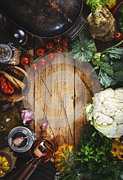 Autumn food background with organic farm vegetables: cauliflower, broccoli, root celery, pumpkin, herbs and spices on rustic wood