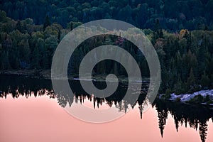 Autumn forest landscape and reflection in the lake at sunset. La Mauricie National Park, Canada