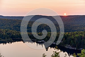 Autumn forest landscape and reflection in the lake at sunset. La Mauricie National Park, Canada