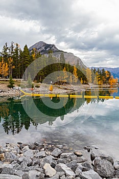 Autumn forest reflected in water. Colorful autumn morning in the mountains. Colourful autumn morning in mountain lake