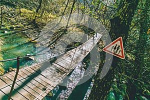 Autumn forest trees beautiful bridge over the river with sign