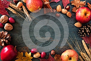 Autumn frame of apples, fall foods & decor on dark stone