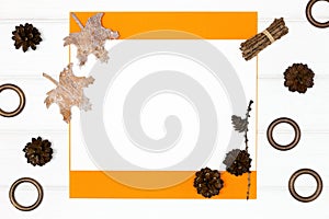 Autumn frame background. Blank paper card with fall season forest decor on white wood boards. Minimal flat lay composition