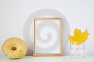 Autumn frame, background. Thanksgiving mockup with golden frame and yellow leaf and pumpkin. Halloween, fall minimal composition