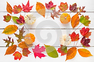 Autumn frame composition of colorful leaves and pumpkins.