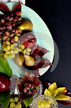 Autumn fruits, apple, grapes and pear.
