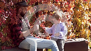 Autumn garden party Father with son. We like autumn time together. Parent teach baby. Father and child having fun at the