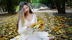 Autumn girl in fashion and lyrics style pick up leaves