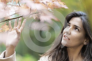 Autumn girl with red maple leaf