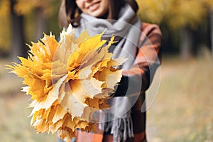 Autumn girl walking in city park. Portrait of happy lovely and beautiful young woman in forest in fall colors. Focus on