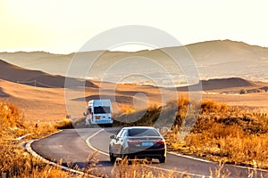 Autumn grassland, country road, car driving