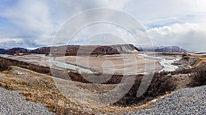 Autumn greenlandic wastelands landscape with river and mountains in the background, Kangerlussuaq, Greenland