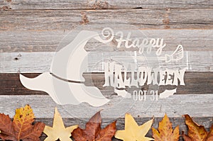 Autumn. Happy Halloween. Fall leaves on wooden background.