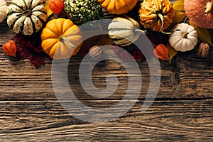 Autumn harvest flat lay. Top view pumpkins, gourds on wooden table. Thankgiving Day banner design