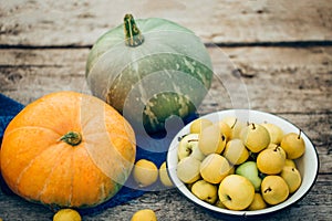 Autumn harvest on the table, apples, pumpkins, wooden background