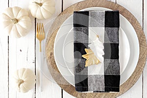 Autumn harvest or thanksgiving dinner table setting. Above view close up on a white wood background.