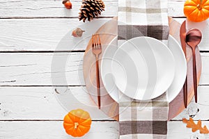 Autumn harvest or thanksgiving dinner table setting over a white wood background