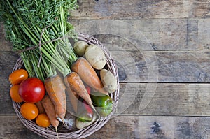 Vegetable basket on a wooden table, in rustic style.