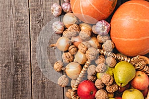 Autumn harvests arranged od the right side of the frame on old wooden boards. Top view of vegetables and fruits. Free space.