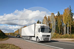 Autumn highway and white truck