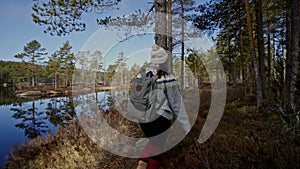 Autumn hike backpacker lifestyle woman walking on trek trail in forest outdoors