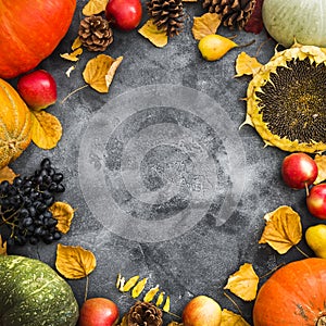 Autumn holiday concept with fallen leaves, vegetables and fruits on old table. Thanksgiving day background, Flat lay, top view