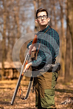 Autumn hunting season. Man hunter with a gun. Hunting in the woods