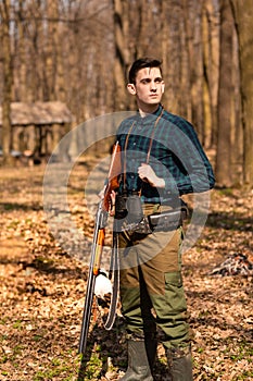 Autumn hunting season. Man hunter with a gun. Hunting in the woods