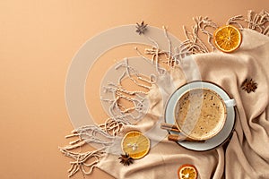 Autumn inspiration concept. Top view photo of cup of frothy hot drinking on saucer cinnamon sticks anise dried orange slices and