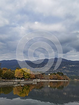 Autumn in ioannina city greece yellow leaves on trees clouds by the lake, greece