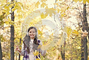 autumn kid fashion. inspiration. happy childhood. back to school. girl with leaves in park. fall beauty in forest. enjoy