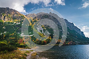 Autumn by lake in High Tatras, Turistic and Hiking photo. Colorful Scenery. Edit space. Popradske lake