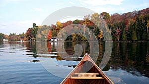 Autumn lake reflection with a canoe
