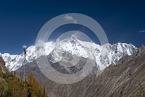 Autumn landscape background with fall colours trees in northern areas of Pakistan