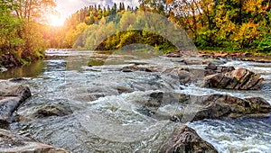 Autumn landscape beautiful colored trees over the mountains river