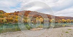 Autumn landscape. Boats on the river near a picturesque hill